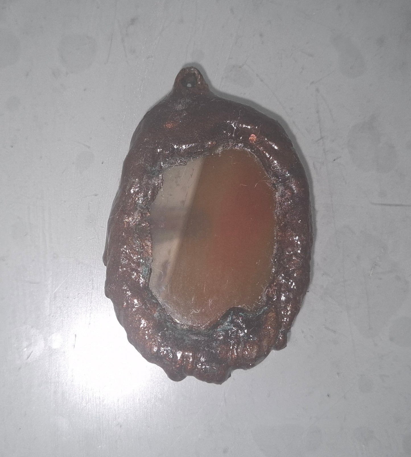 Electroformed copper pendant with enclosed orange agate disc