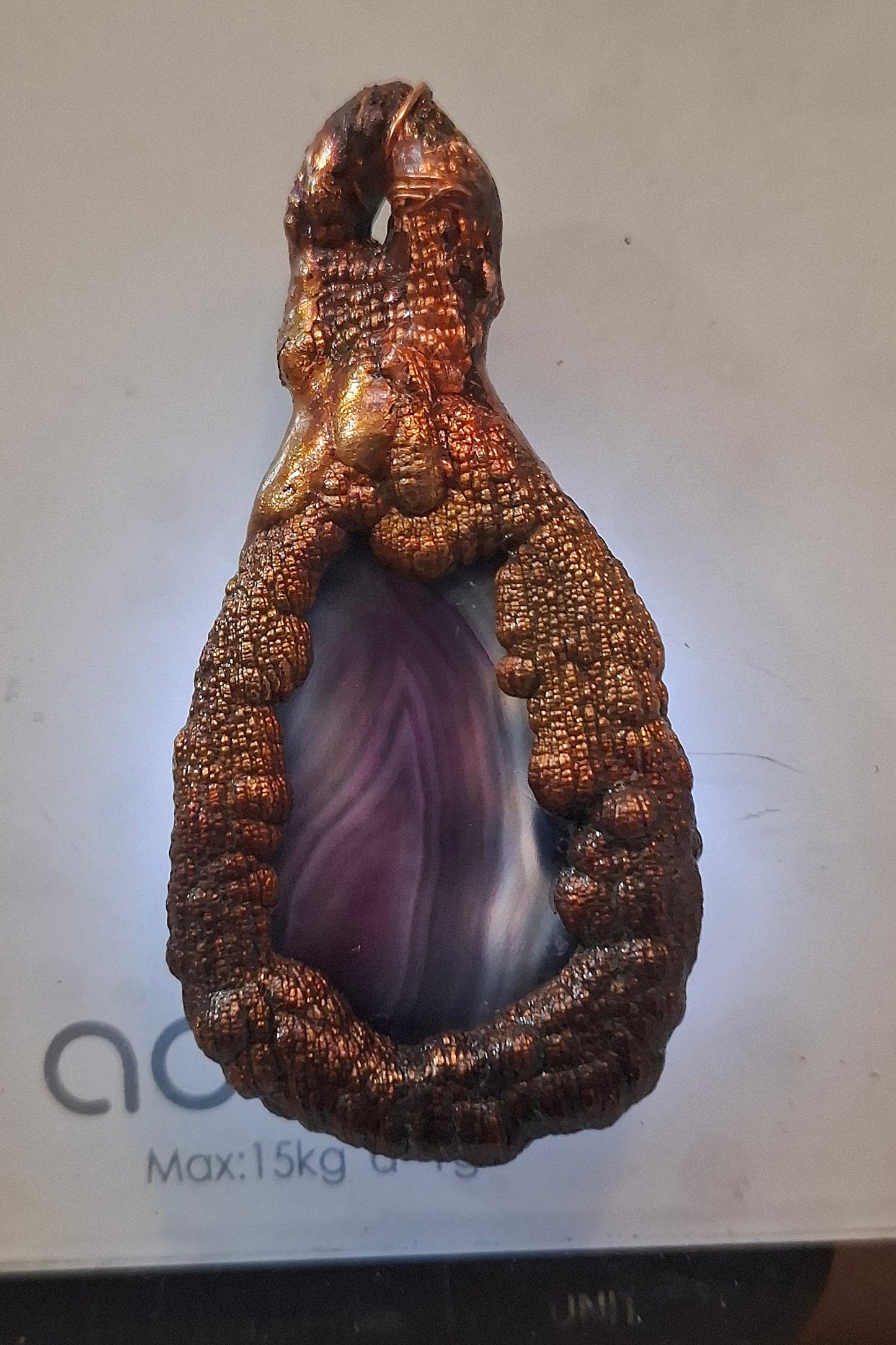 Electroformed copper pendant with enclosed violet agate disc with iridescent patina