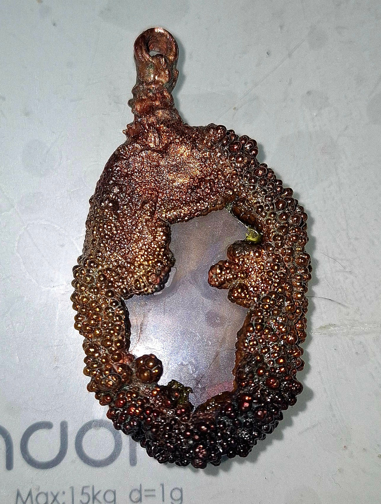 Electroformed copper pendant with enclosed transparent agate disc with iridescent patina